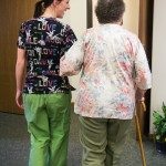 nurse and elderly woman walking