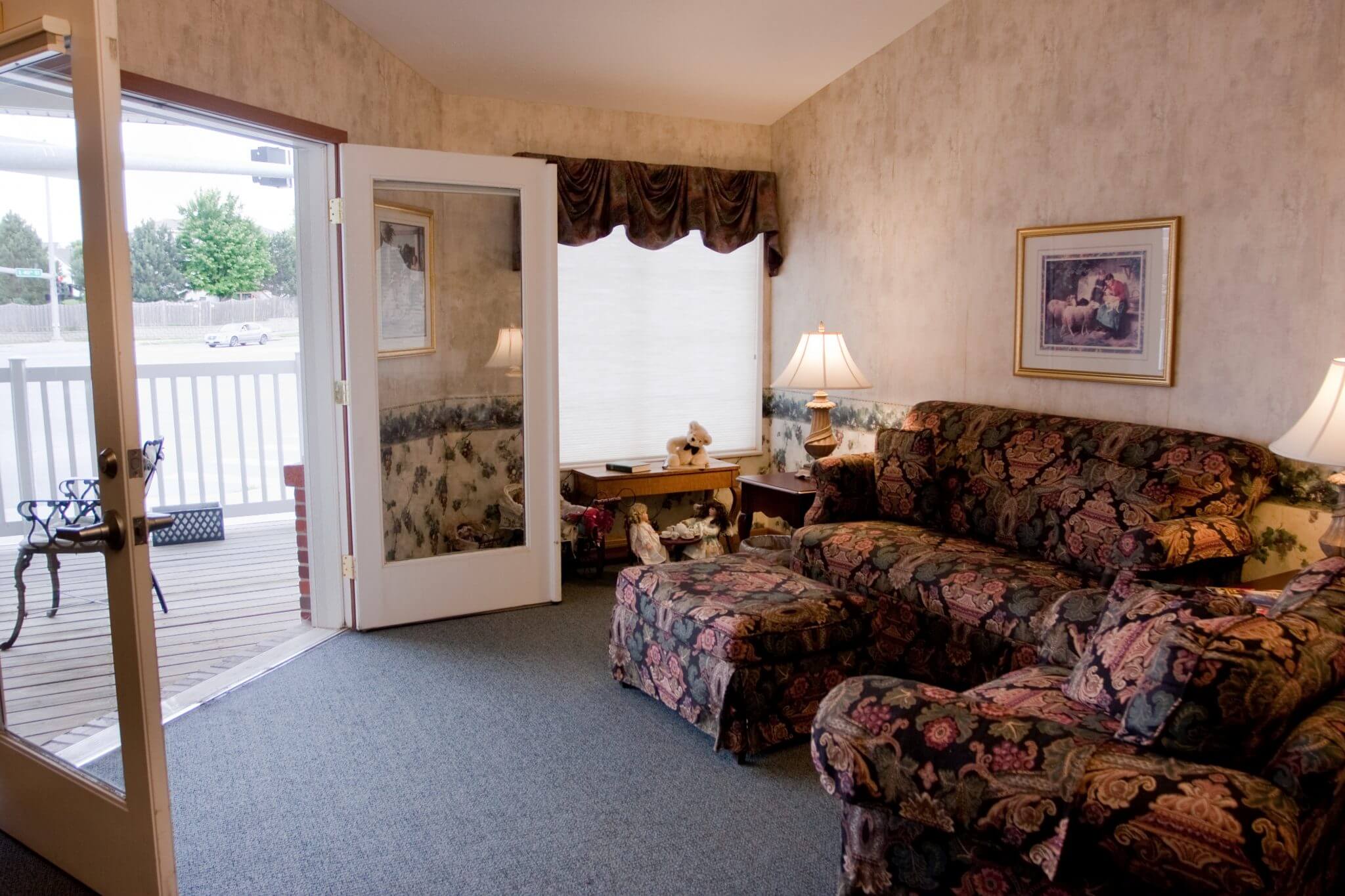 interior shot of living room with french doors opening to porch