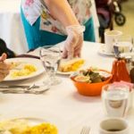 nurse serving elderly people pie