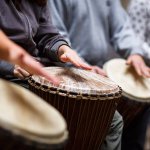 people playing drums as music therapy