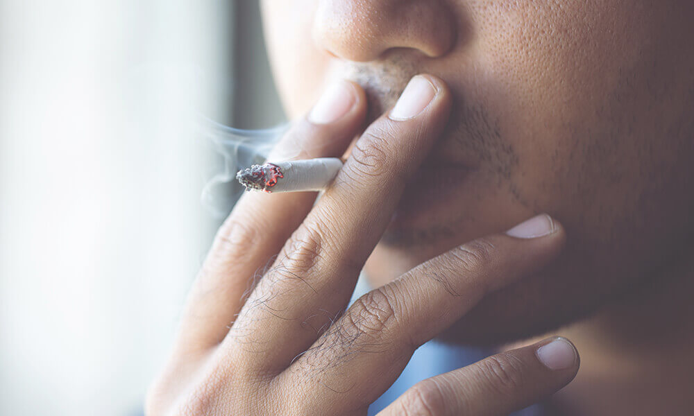 a young man addicted to cigarettes