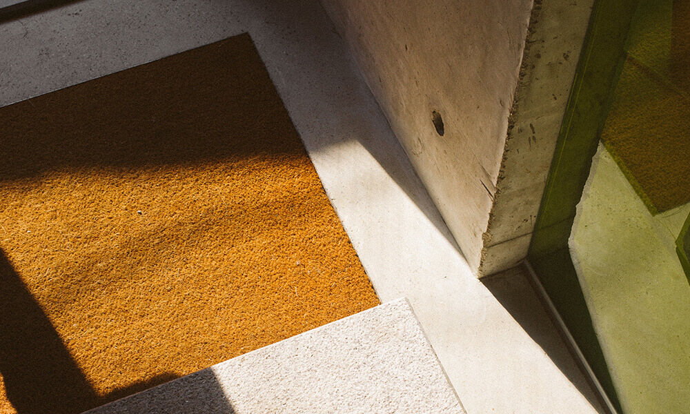 a doormat on a well lit entryway