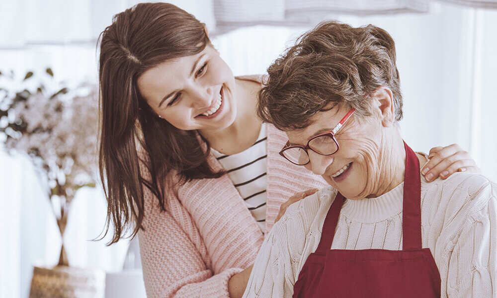 young female student laughing with senior living partner